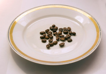 coffee beans on a white saucer
