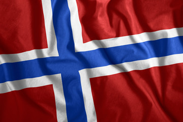 Fototapeta premium The Norwegian flag is flying in the wind. Colorful national flag of Norway. Patriotism, patriotic symbol.
