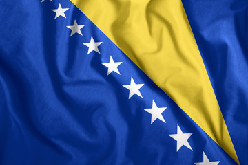 Bosnia and Herzegovina flag fluttering in the wind. Colorful national flag of Bosnia and...