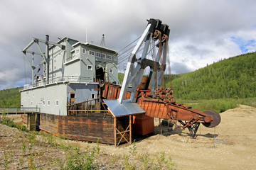 Fototapeta premium The remains of a historical delelict gold dredge on Bonanza creek near Dawson City, Yukon, Canada