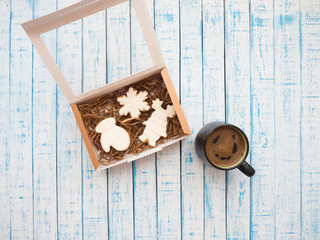 Gingerbread in packaging and coffee on an old table in French style