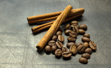 Cinnamon sticks and coffee beans on a black background