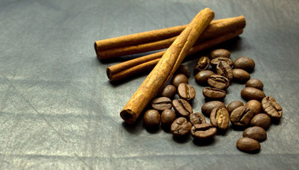 Cinnamon sticks and coffee beans on a black background
