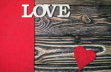 Fototapeta na wymiar letter love carved out of wood in the background. Decorations for the holiday of Valentine's day, mother's day or wedding day