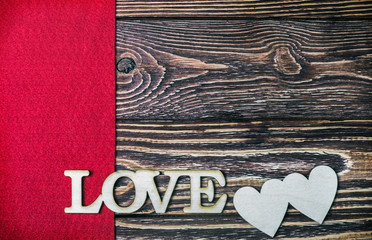 letter love carved out of wood in the background. Decorations for the holiday of Valentine's day, mother's day or wedding day