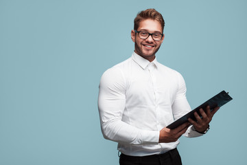 Smiling businessman with clipboard