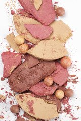 Heap of various crashed makeup products