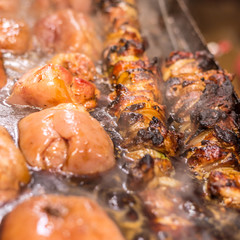 Fresh meat shish kebab with pork knees prepared on a grill.