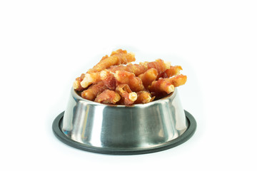 Chicken bone in stainless bowl for dog isolated on white. Snack for pets concept.