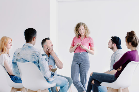 Teenage girl speaking to colleagues