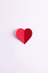 red paper heart on a white background