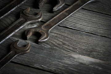 Dirty set of hand tools on a wooden background. Old rusty tools Sales tools for assembly workers.  Old shop Old working. Vintage working tools (drill, saw, ruler and others) on wooden background