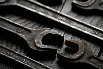 Dirty set of hand tools on a wooden background. Old rusty tools Sales tools for assembly workers.  Old shop Old working. Vintage working tools (drill, saw, ruler and others) on wooden background