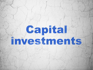 Money concept: Blue Capital Investments on textured concrete wall background