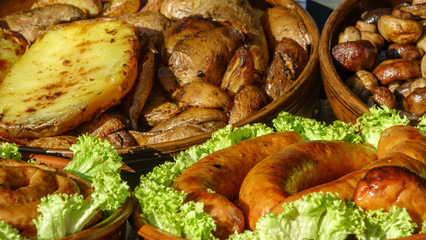 Potatoes, mushrooms champignons and grilled sausages