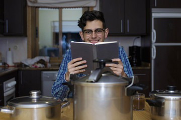 learning to cook with cookbook and pots