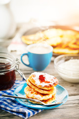 Delicious pancakes on wooden table with Cup of coffee and jam