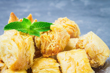 baklava turkish traditional delight on a dark wood background. toning.