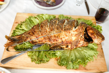 Fried fish on a banquet table in a restaurant