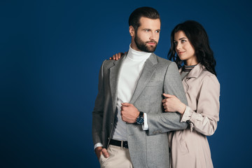 girlfriend hugging boyfriend isolated on blue