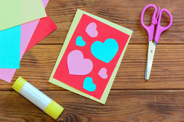 Valentines day or Mothers day postcard with pink and blue hearts. Scissors, glue stick, colored...