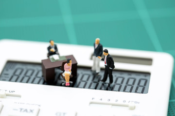 Miniature people : businessman and secretary with caculator , Business concept.