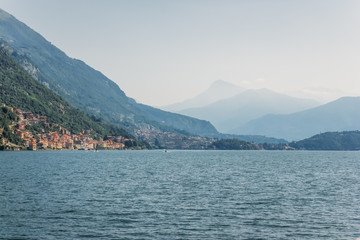 Fototapeta na wymiar view of mountain lake and hills on shore with buildings during daytime, Lake Como, Italy
