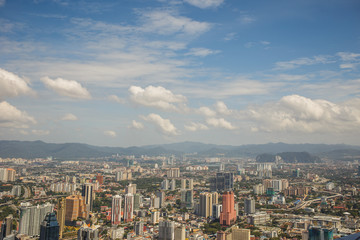 Fototapeta na wymiar Urban views of Kuala Lumpur with tall skyscrapers, drowning in the greenery of parks