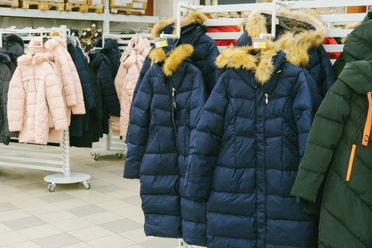 Winter color jackets on stands in store