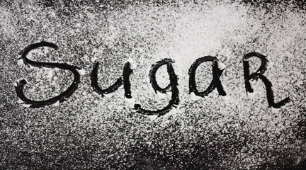 the word Sugar written with sugar powder