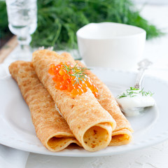 Homemade pancakes with red caviar for carnival, square