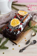 Christmas chocolate cake with berries on a light background (close-up)