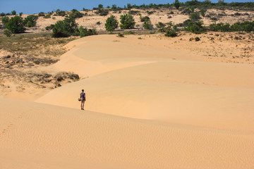 Fototapeta na wymiar back view of lonely person standing in desert, Vietnam, Phan Thiet
