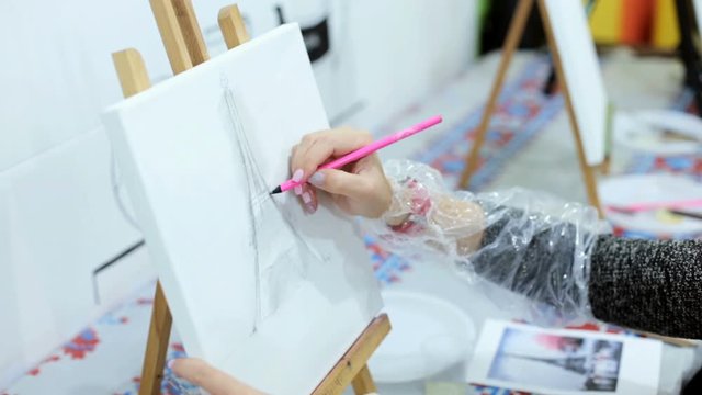 A young artist draws a picture