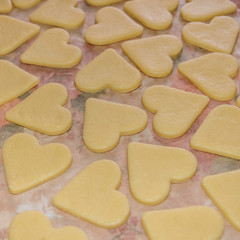raw cookies in the shape of hearts, top view.