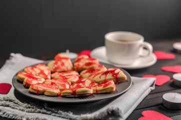 cookie-hearts, paper hearts, candles, boxes with presents and a Cup of black coffee, congratulation with Valentine's day.