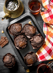 Chocolate muffins with fresh tea.