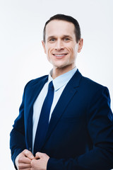 Successful businessman. Cheerful smart nice man looking at you and smiling while being a successful businessman