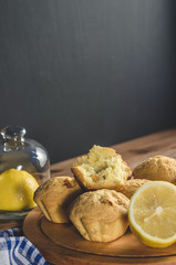 Lemon cupcakes on a wooden Board on the table with a blue towel. Free space for text.