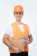 Engineering projects. Nice cheerful positive man holding a folder and smiling while thinking about his engineering projects