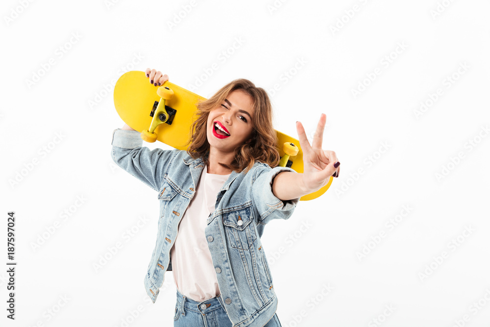 Poster happy woman in denim clothes with skateboard having fun