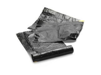 Black roll of plastic garbage bags isolated on white
