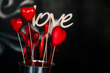 Valentine day love beautiful. Heart gaarland hanging on branch of tree on, photo zone with photo props and kissing booth