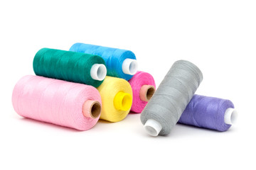 Set of colorful spools of thread isolated