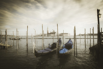 Fototapeta na wymiar Gondolas on the waterfront of St Mark's Basin with San Giorgio Maggiore and Giudecca island in the background