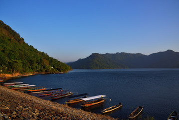 Small wooden boat in the lake