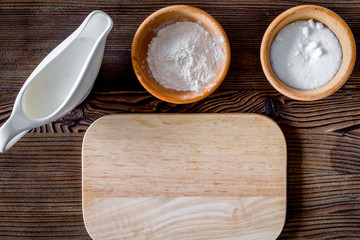 Put the dough. Ingredients on dark wooden table background top v