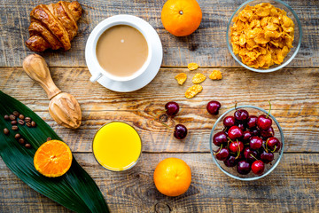 Light summer breakfast. Muesli, oranges, cherry, croissant and c