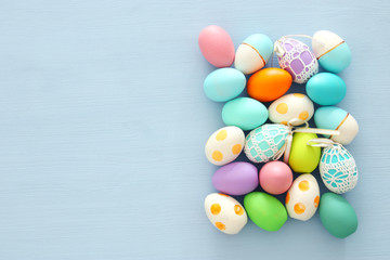 Fototapeta na wymiar Top view of easter colorful eggs over blue background.