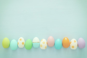 Top view of easter colorful eggs over blue background.
